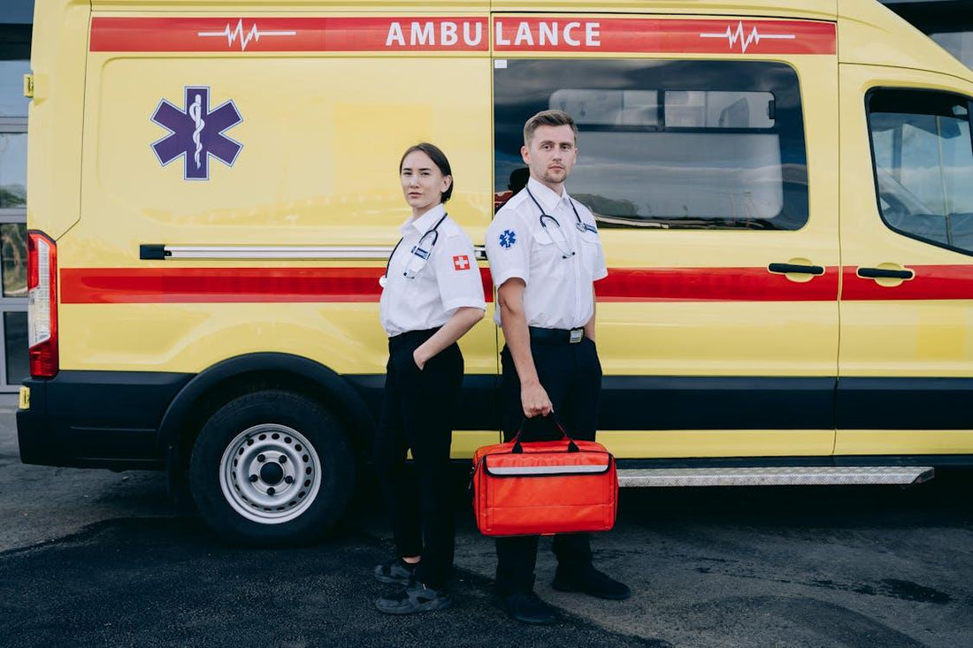 Paramedics standing beside an ambulance, ready for deployment
