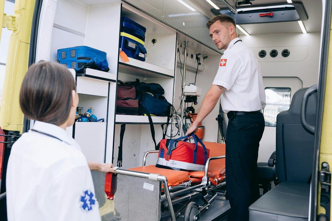 Paramedic retrieving a medical bag and coordinating with team member beside a stretcher
