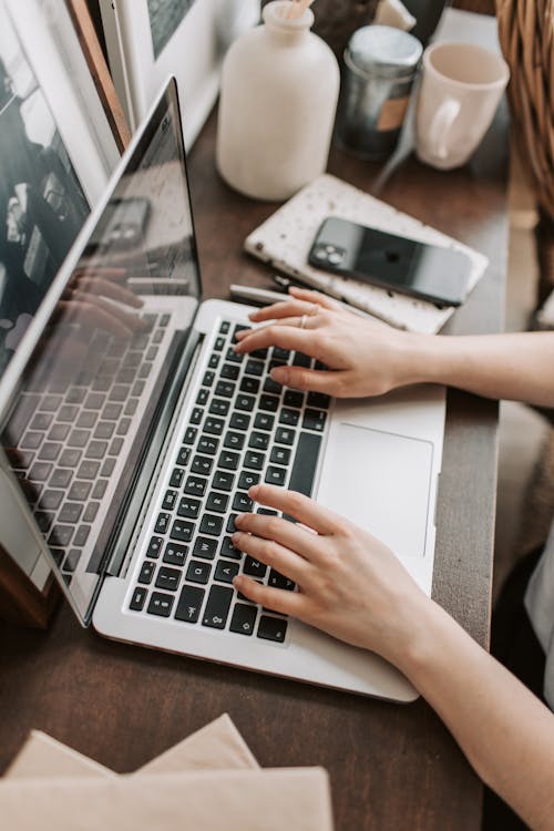 Student scheduling the NREMT exam on a laptop at home