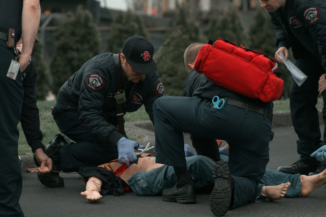 EMS first responders practicing emergency response during an outdoor training simulation