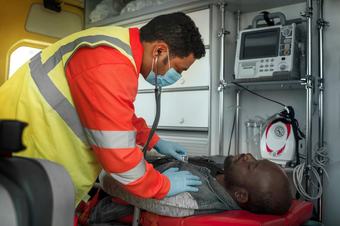 Paramedic checking an injured patient during a medical emergency response