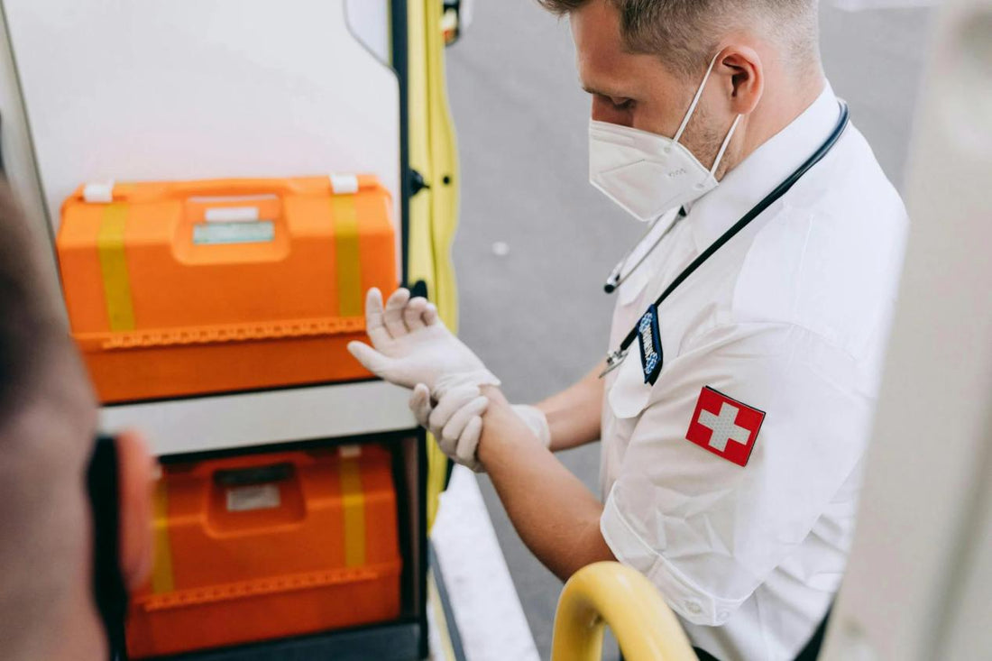 Paramedic in a face mask putting on gloves before a call