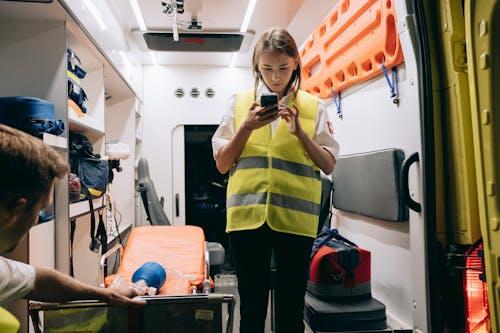 Paramedic using a cell phone inside an ambulance