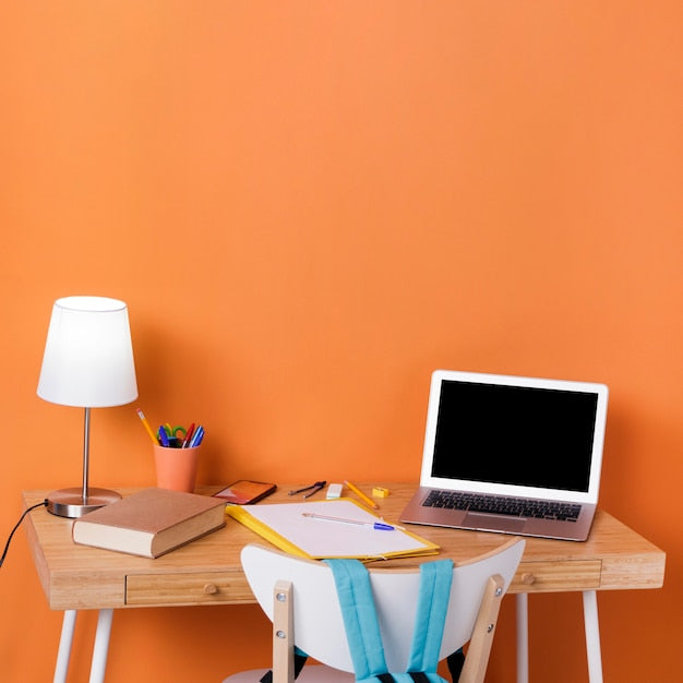 Cozy study nook with desk and books in a well-organized space.