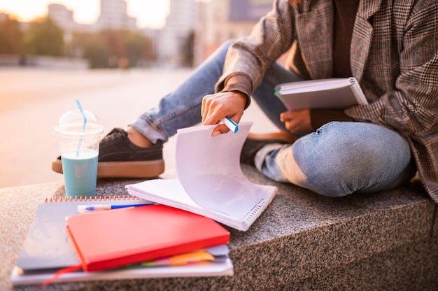 Woman studying outdoors in a city.