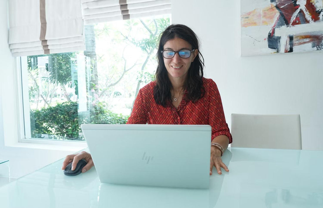 A focused woman studying for the NREMT exam at home.